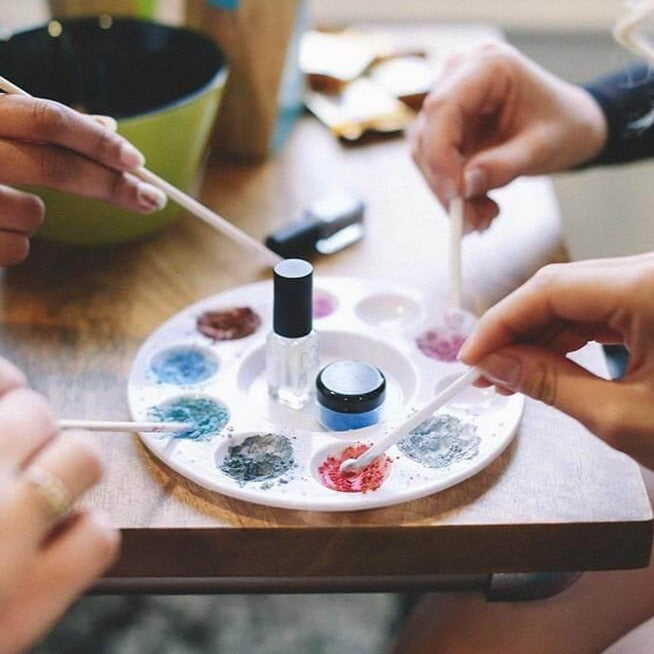Women making nail polish using DIY nail polish kit. Close up of hands