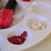 Close up of red Mixify Beauty nail polish with red and white micas in a palette