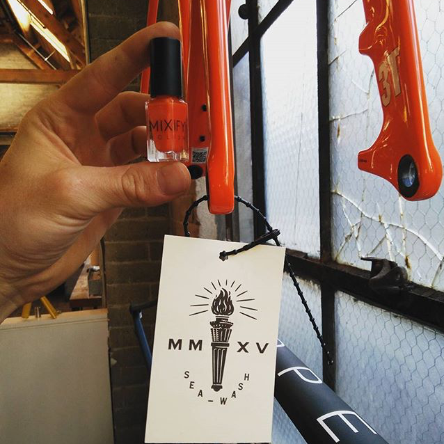 Man holding custom made nail polish for bike paint repair
